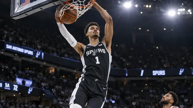 Victor Wembanyama performing a powerful two-handed dunk for the San Antonio Spurs